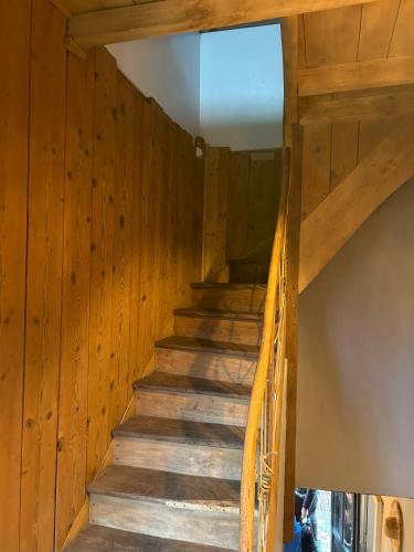 a staircase in a wooden house with wooden walls at Gîte le clos Margherite 14 personnes piscine in Saint-Sorlin-de-Morestel