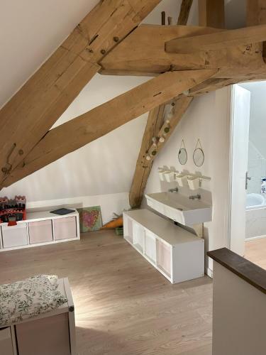 a attic room with white furniture and a sink at Gîte le clos Margherite 14 personnes piscine in Saint-Sorlin-de-Morestel