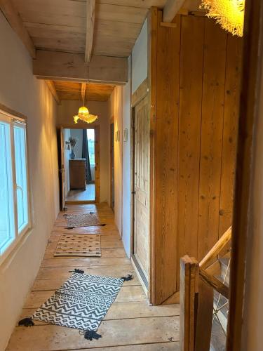 a hallway of a house with wooden walls and wood floors at Gîte le clos Margherite 14 personnes piscine in Saint-Sorlin-de-Morestel
