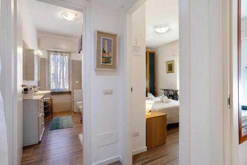 Ein weißes Zimmer mit einem Bett und einem Bad. in der Unterkunft Casa di Lucy e Max in Brugherio