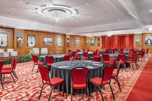 a conference room with tables and chairs and a chandelier at Dom Pedro Lisboa Hotel, a member of Radisson Individuals in Lisbon