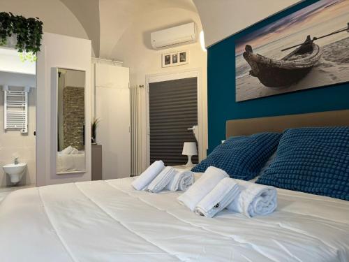 a bedroom with a white bed with towels on it at ZAC 38 in Polignano a Mare