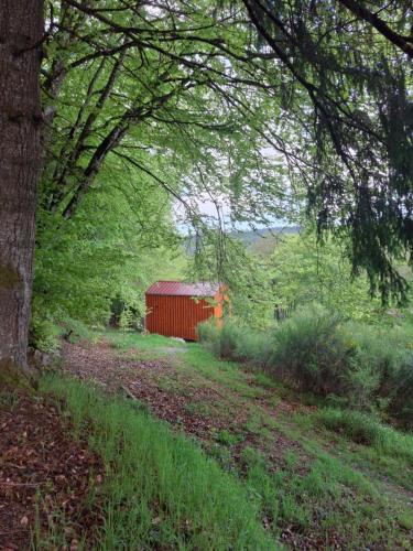 a red barn sitting in the middle of a field at Terre d'oyali in Saint-Rirand