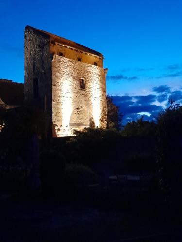an old building with lights on it at night at La Maison du Prince de Condé in Charroux-dʼAllier