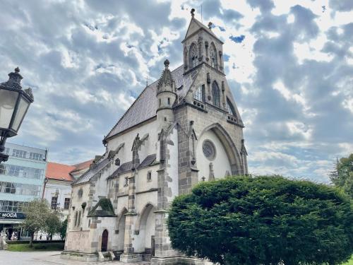 an old church with a tower on top of it at Central Apartment with Cathedral View in Košice