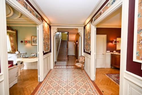 a hallway of a home with a stairway at Château de la Chaix in Saint-Christophe-en-Brionnais