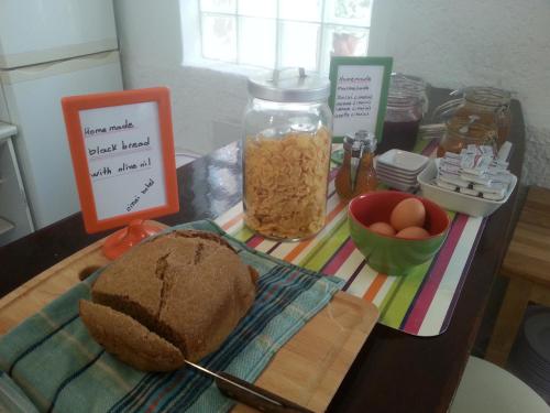 a table with a loaf of bread and a jar of food at Oinoi Hotel in Agios Kirykos