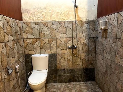 a bathroom with a toilet and a shower at Citronella in Klungkung