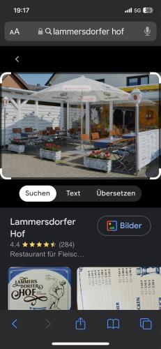 a screenshot of a cell phone with a picture of a pavilion at Landgasthaus zum Lammersdorferhof in Simmerath