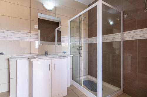 a bathroom with a shower and a sink at Studio Maya Mindelo in Mindelo