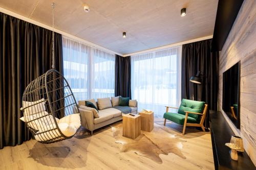 a living room with a couch and a swing at GRIMMINGlofts in Bad Mitterndorf