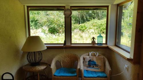 a window in a room with two chairs and a lamp at Domaine La Bonne Etoile in Le Faouët