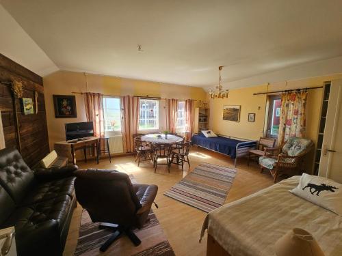 a living room with a couch and a table at Bo på lantgård in Motala