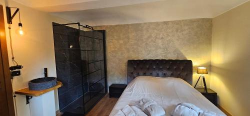 a bedroom with a bed with a black head board at Villa Fonte in Ferrere