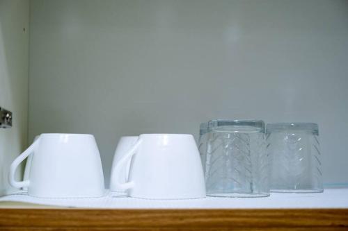 three glass jars sitting on top of a shelf at 2BR Fully Air-Conditioned Staycation PLUS Free Parking in Manila