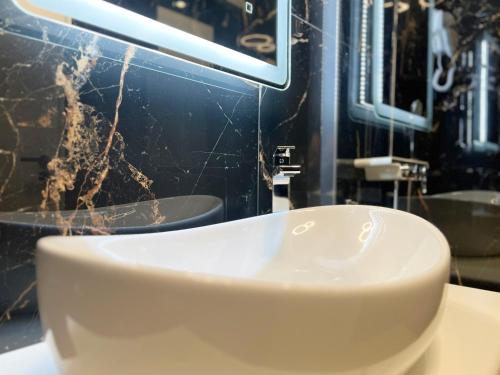 a bathroom with a white sink on a counter at Private room Niko in Skradin