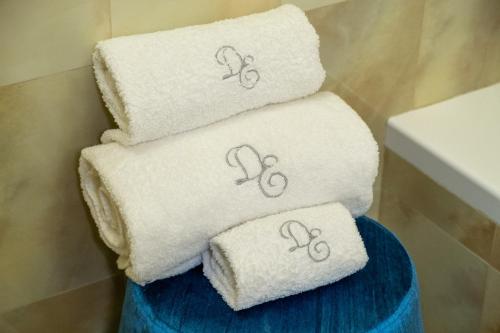a pile of towels with numbers on them in a bathroom at Dimora EgiLò in Nardò