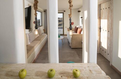 two apples sitting on a table in a living room at Casa di Mare Luxury Villas in Imerovigli