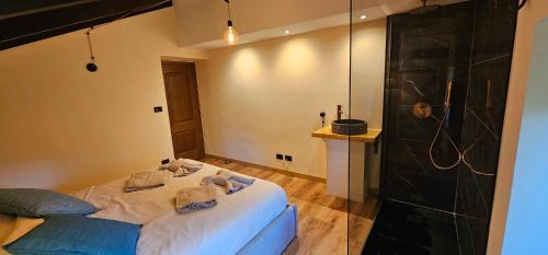 a bedroom with a large bed and a shower at Villa Fonte in Ferrere