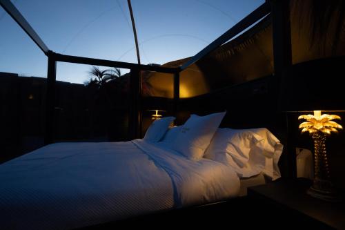 a bed with white sheets and pillows in a room at burbujas del sella in Ribadesella