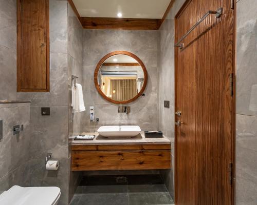 a bathroom with a sink and a mirror at The Highland Ladakh in Leh