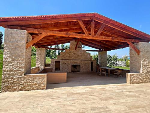 an outdoor patio with a brick oven with a table at Arena Apartments & Villas Guba in Quba