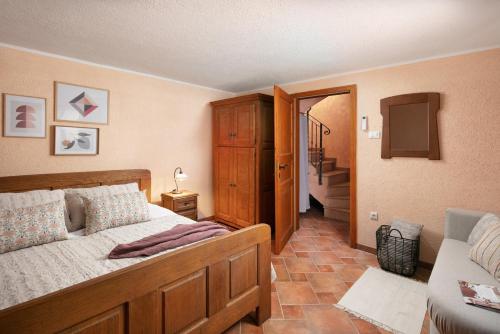 a bedroom with a bed and a television and a staircase at Ferienhaus Antonia Cittanova in Novigrad Istria