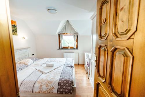 a bedroom with a bed and a window and a door at Zelena Oaza - B&B in Miklavž pri Ormožu