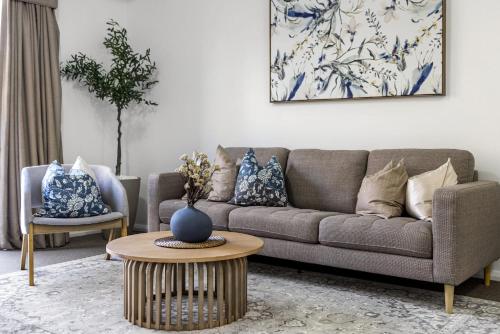 a living room with a couch and a table at Northbridge Hideaway 2BDR 1BTH in Perth