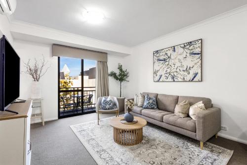 a living room with a couch and a table at Northbridge Hideaway 2BDR 1BTH in Perth