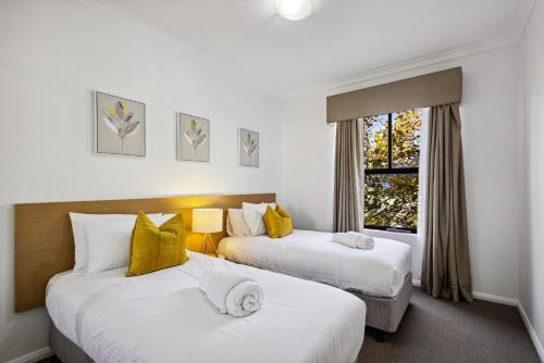 a hotel room with two beds and a window at Northbridge Hideaway 2BDR 1BTH in Perth