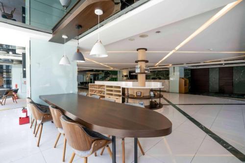 a dining room with a wooden table and chairs at CHECK inn SELECT Hualien LinSen in Hualien City