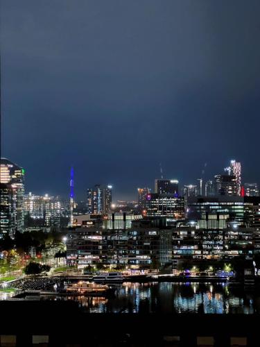 a view of a city at night with at Luxury Docklands Loft 2B1B River view & Free parking in Melbourne