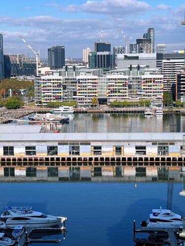 a view of a city with boats in the water at Luxury Docklands Loft 2B1B River view & Free parking in Melbourne