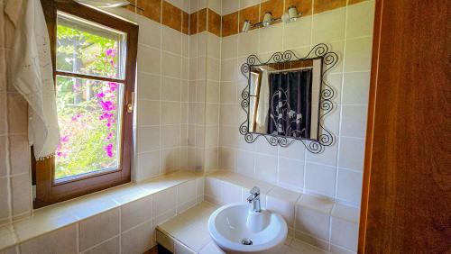 a bathroom with a sink and a window at Villa Palma Posidi with Private pool in Kalandra