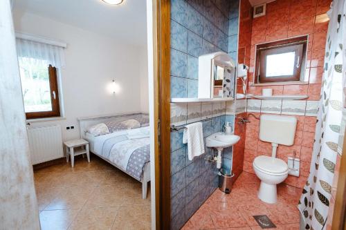 a bathroom with a bed and a toilet and a sink at Zelena Oaza - B&B in Miklavž pri Ormožu