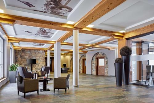 a lobby of a hotel with chairs and tables at Lindner Hotel Nurburgring Motorsport, part of JdV by Hyatt in Nürburg