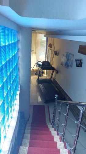 a room with a gym with a treadmill and a window at Resort altayar Villa altayar 1 Aqua Park with Sea View in Sidi Krir 