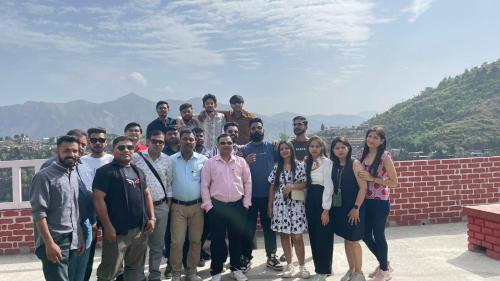 a group of people posing for a picture on a roof at The Himalaya Retreat Resort, Experience Nature in the Lap of Himalayas in Mussoorie