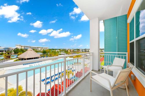a balcony with a view of the pool and the ocean at Embassy Suites By Hilton Orlando Sunset Walk in Kissimmee
