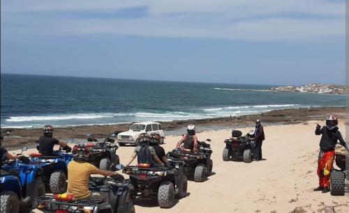 a group of people riding atvs on the beach at Hôtel lhamra in Agadir