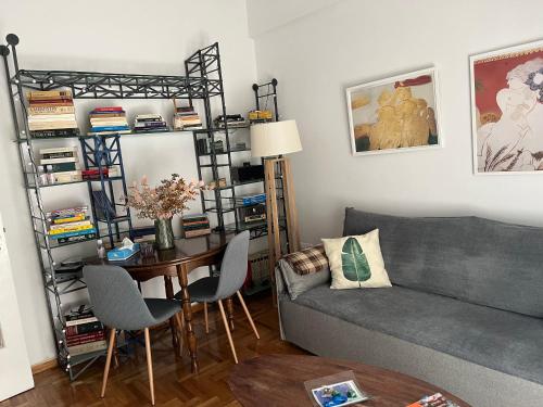 a living room with a couch and a table at Alex’s home next to Laiko in Athens