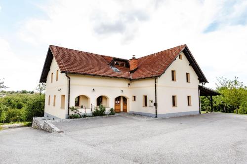 a large white house with a large driveway at Zelena Oaza - B&B in Miklavž pri Ormožu