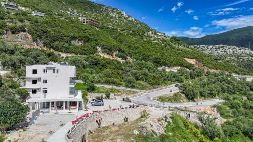a building on a hill next to a road at Seaview Bunec in Piqeras