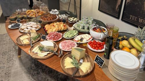 a table with a bunch of food on it at Relais Villa dei Gelsi & Spa in Verona