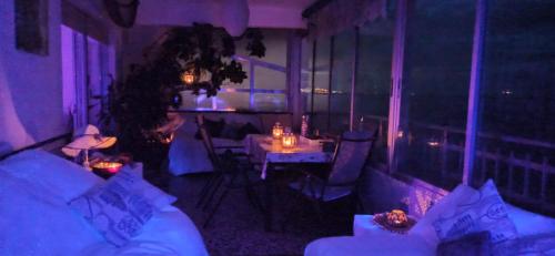 a living room with a couch and a table with lights at SUNSET ROOM AT FRONT BEACH - HABITACION EN LA PLAYA en Piso compartido in Tavernes de Valldigna