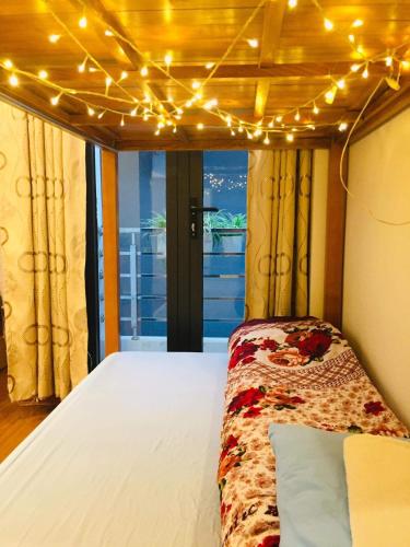 a bedroom with a bed with lights on it at Primrose Homestay Cao Bang in Cao Bằng