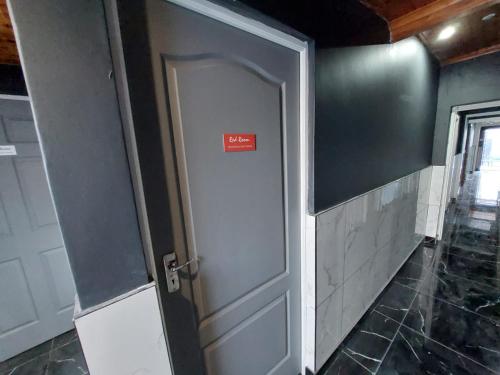 a door in a room with a sign on it at Freedommedia guesthouse in Gqeberha