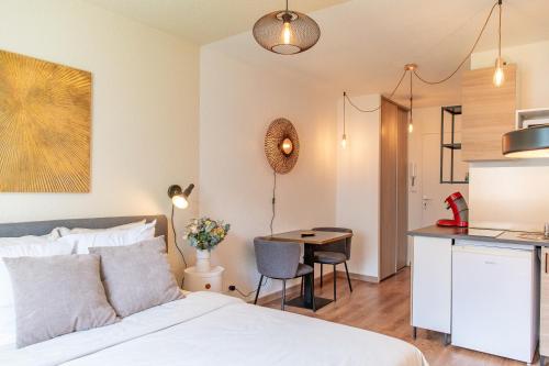 une chambre avec un lit et une cuisine avec une table dans l'établissement Lyon centre appartement meublé, à Lyon
