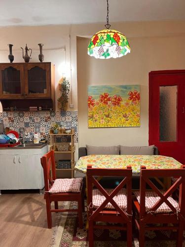 a kitchen with a table and a dining room with a table and chairs at Almadovarhouse in Makhinjauri